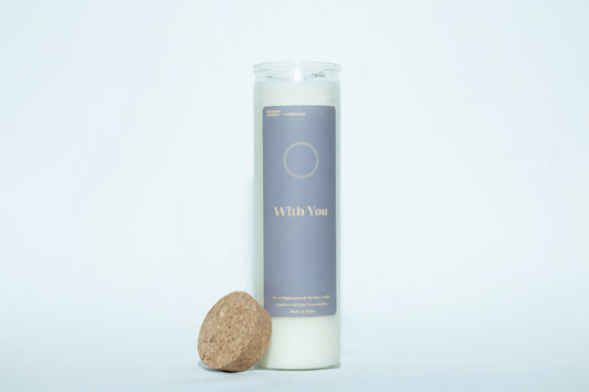 Candle labeled 'With You' with a cork base on a white background