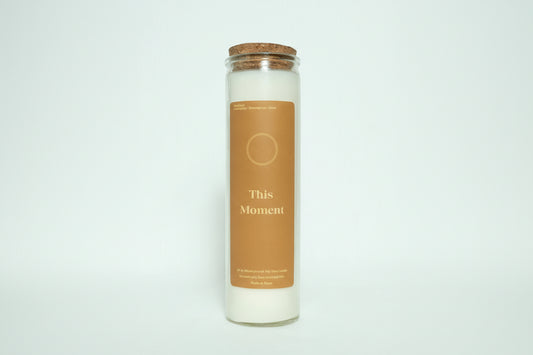 Candle in a glass jar with a cork lid on a white background