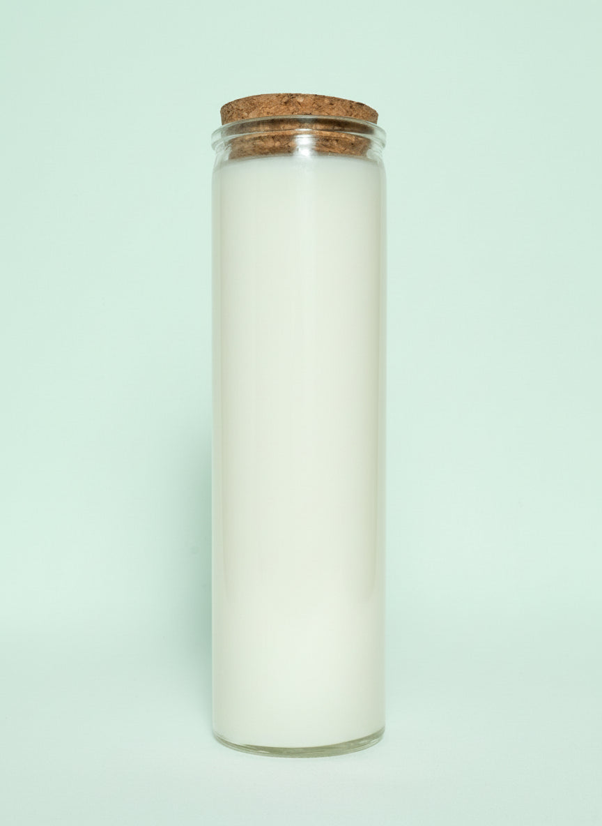 Candle in a glass jar with a cork lid on a white background
